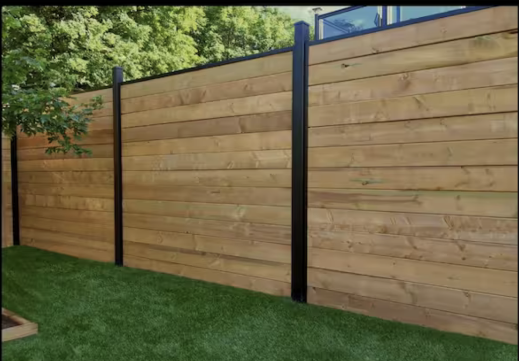 horizontal wood privacy fence with black metal posts in michigan